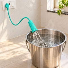 The teal and silver electric immersion water heater rod is submerged in a metal bucket of boiling water, plugged into a wall