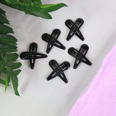 Matte metal hair clips arranged in pastel and bold shades