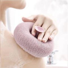 Flower-shaped bath sponge in hand during shower
