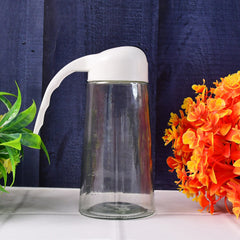 Glass bottle dispenser standing upright with closed lid