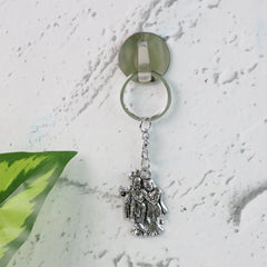 Radha Krishna metal keychain on white background
