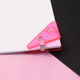 Close-up of triangle paper clip on paper corner