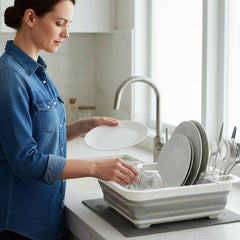 Dish drying rack with integrated drain tray on kitchen sink