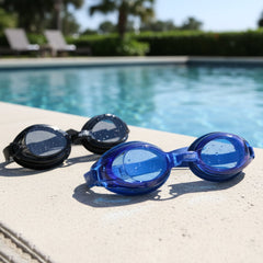 Pair of swimming goggles laid out on white background