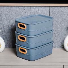 3 plastic storage baskets with handle cutouts in colorful design