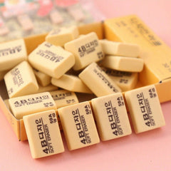 Group of yellow 4B erasers on a desk