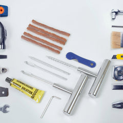 Tire repair kit tools arranged inside the storage box