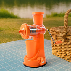 Manual juicer with fresh orange juice and fruits