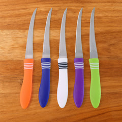 Serrated knife easily slicing through a tomato, demonstrating sharpness.