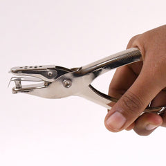 Single hole puncher design showing spring mechanism
