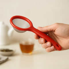 Apex tea strainer with ergonomic handle on wooden surface