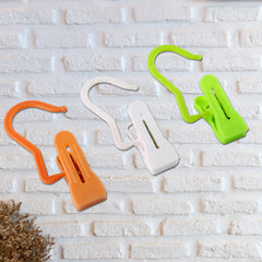 Multipurpose clip clipped onto fabric