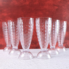 Milkshake glass showing footed base and diamond-cut texture