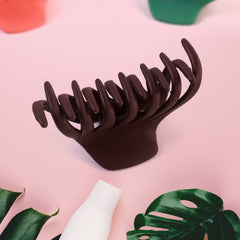 Matte plastic hair clamp on white background