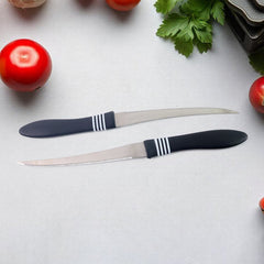 Serrated stainless steel knife slicing a tomato