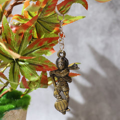 Lord Hanuman metal keychain from a side angle
