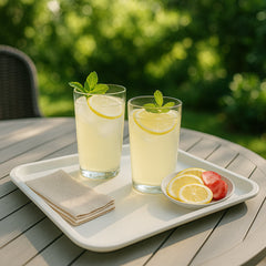 Stack of multiple white rectangular serving trays, showcasing their space-saving design.