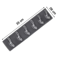 Golden and transparent 6-pin hooks mounted on bathroom wall