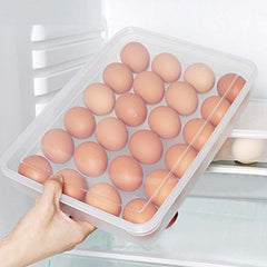 Hand pulling out a clear 24-grid egg container from a fridge shelf