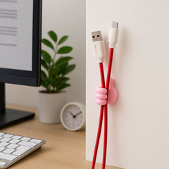 Close-up of pink hand-shaped cable and key holder