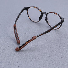 Silicone grips attached on eyeglass arms preventing slipping
