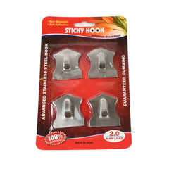 Sticky hooks attached to kitchen wall hanging utensils