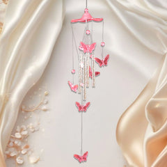 Wind chime with twinkling butterfly wings in sunlight
