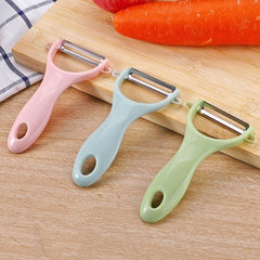 Green plastic kitchen peeler with curved handle and stainless steel blade