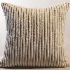 Corduroy pillow cover displayed on a sofa with cozy throw