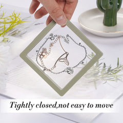 Clear floating frame jewelry display case with necklace and earrings