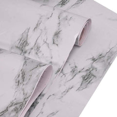Application of peel and stick marble wallpaper on kitchen counter