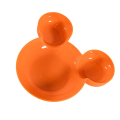 Child's hands reaching for food on a red Mickey Mouse plate