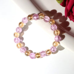 Close-up of crystal beads on dual-tone stretch bracelet