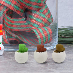 Multiple dinosaur erasers displayed on white background