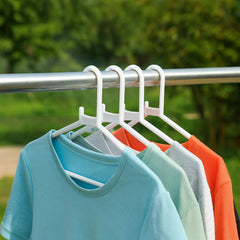 Close-up of a single white plastic clothes hanger