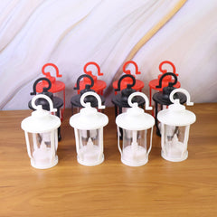 Lantern style flameless LED candles on bedside table