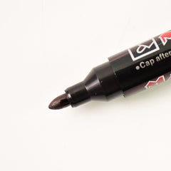 Black ink whiteboard marker showing its refillable tip