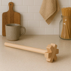Wooden blender smashing ingredients in bowl