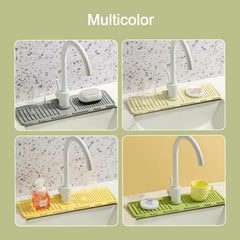 Silicone faucet splash guard in use in a kitchen sink