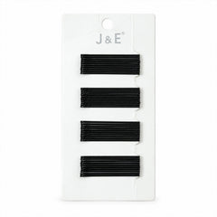 A black bobby pin is measured at approximately 6 cm on a light brown background.