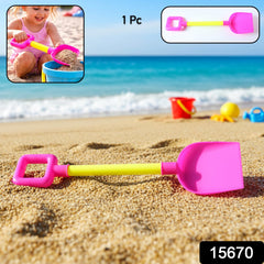 Child holding digging shovel at beach