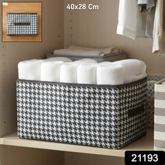 Fabric storage basket on shelf organizing clothes