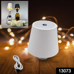 Wiress USB table lamp glowing inside a wine bottle in indoor setting