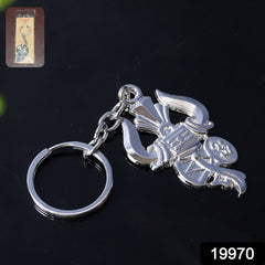 Close-up of metal keychain showing Trishul and Damru details