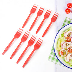 Red disposable forks on table setup