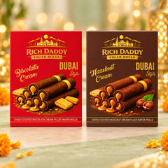 Two boxes of Rich Daddy wafer rolls, one red for Biscolata Cream and one brown for Hazelnut Cream, with golden accents on a