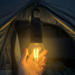 Solar camping lamp illuminating an outdoor campsite