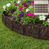 Plastic decorative garden fence border installed around flowers