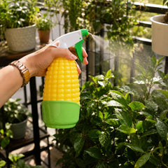 A hand using the water sprayer for plants, demonstrating fine mist.