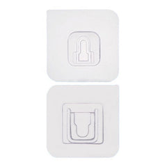 White adhesive hooks mounted on smooth wall